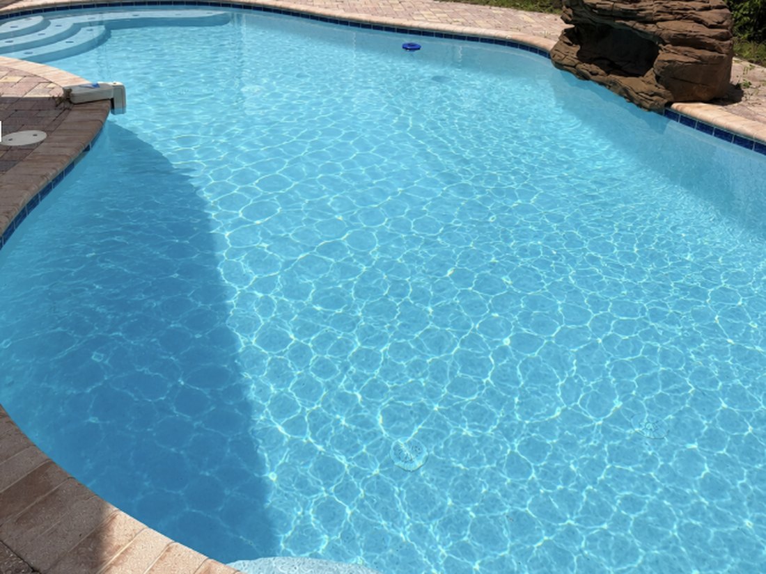 Crystal clear blue pool after Crystalline Pools cleaning service